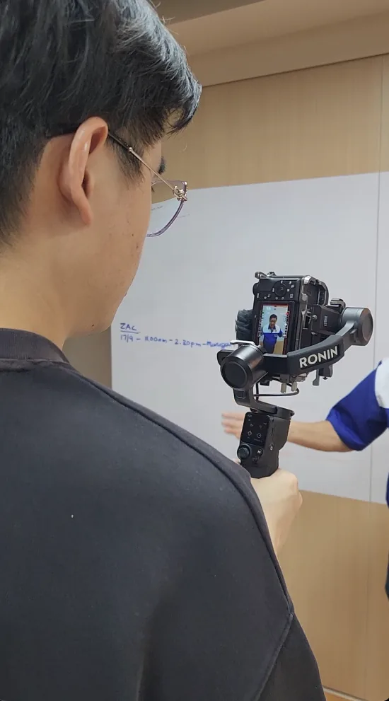 A Drealm native-content shoot: a creator on camera with lighting and a phone rig, filming for the TikTok feed