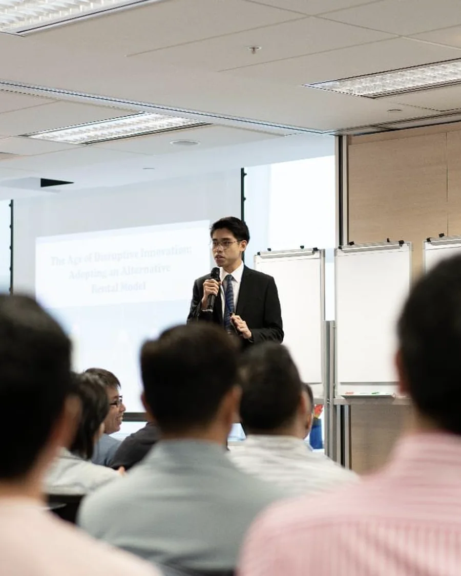 Tom Chang Thawat, co-founder of Drealm, presenting to a full training room