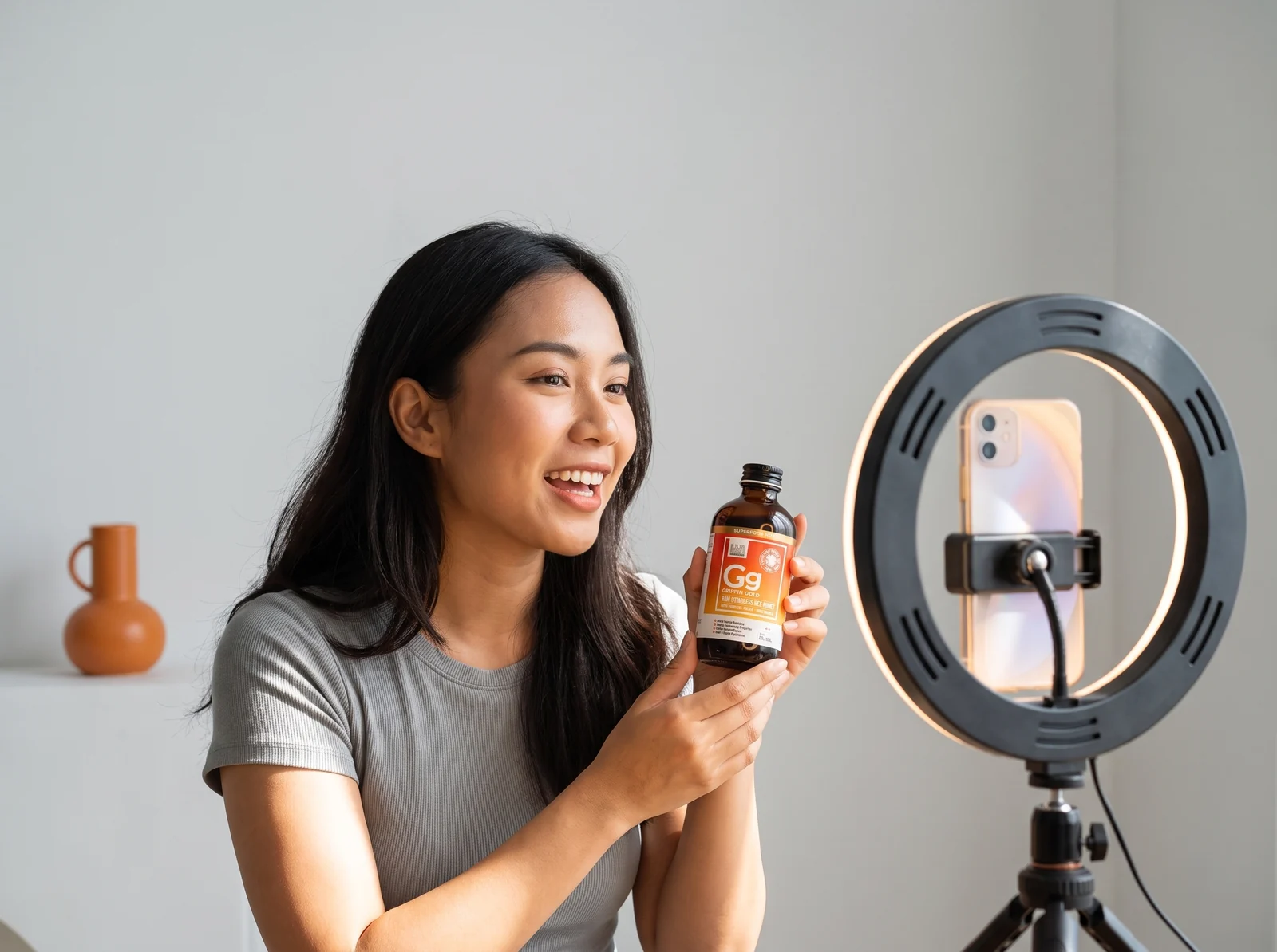 A Drealm creator filming native product content with a ring light and phone